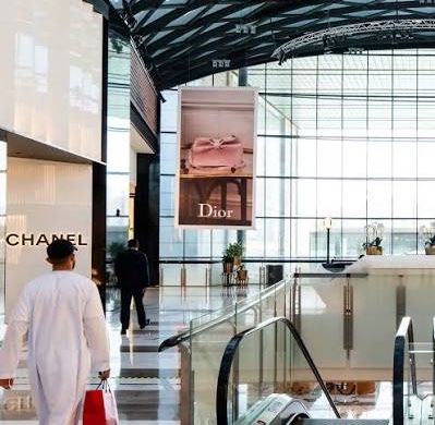 Luxury mall interior with premium brand storefronts
